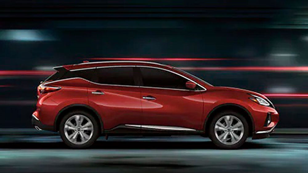2023 Nissan Murano shown in profile driving down a street at night illustrating performance. | JP Nissan in Blytheville AR